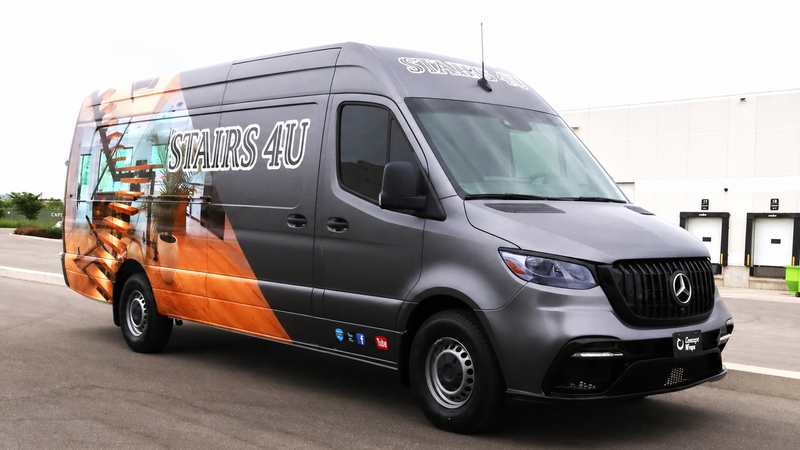 Gray van with colorful design and 'STAIRS 4U' branding on a road.